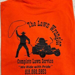 An orange tee screen printed with The Lawn Wrangler logo and phone number
