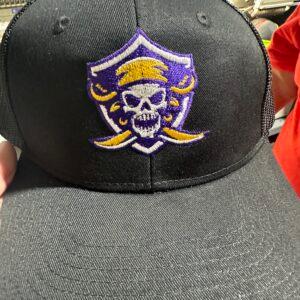 A black trucker cap embroidered with a purple and gold pirate skull crest