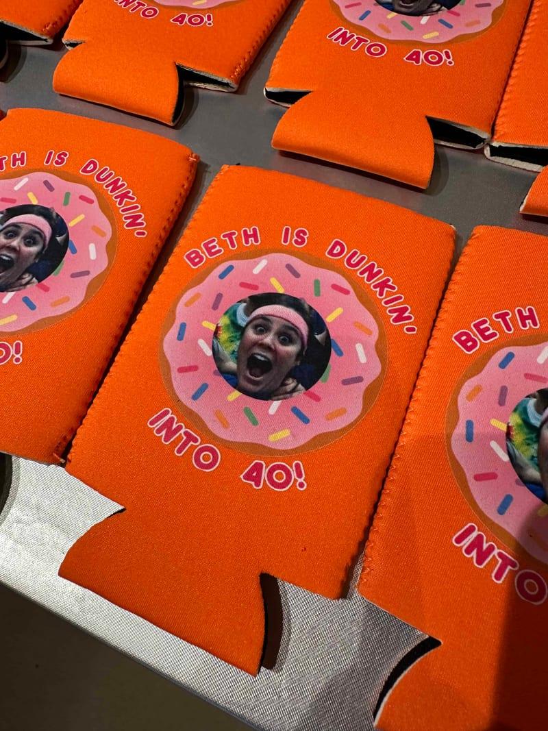 Orange neoprene can coolers printed with a doughnut design for a fortieth birthday