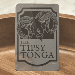 A laser engraved metal plaque for The Tipsy Tonga, centred on a ram's head crest
