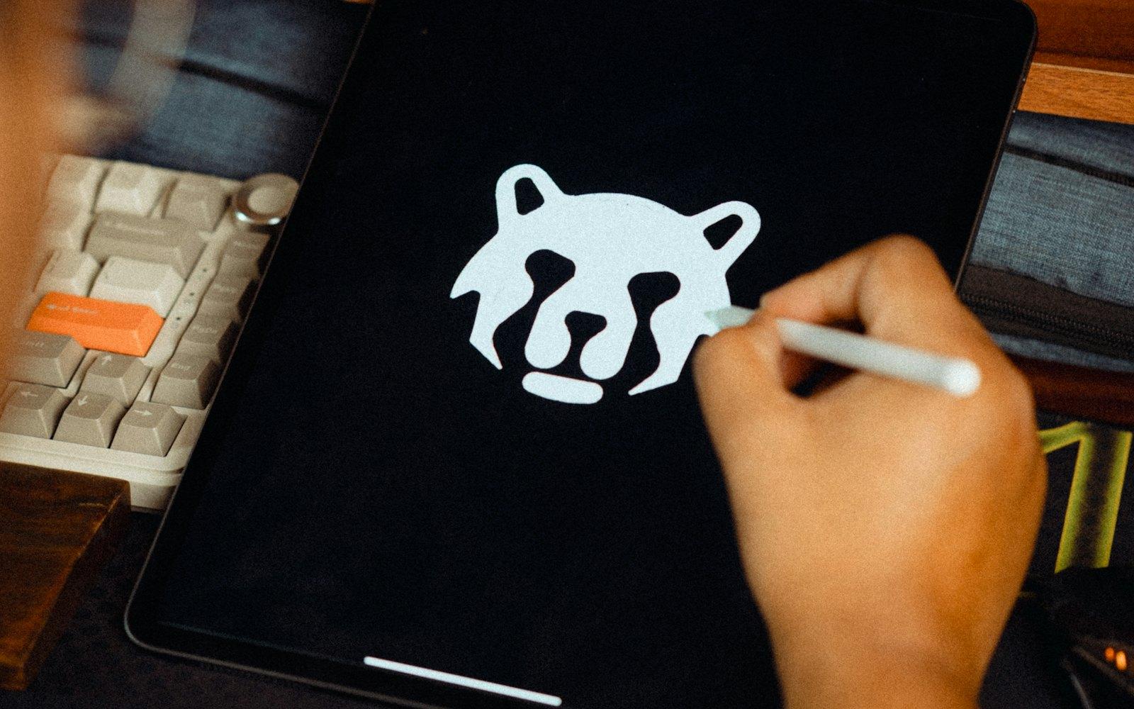 A designer drawing a logo on a tablet with a stylus
