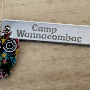 Custom printed Camp Wannacomback keychain with owl design.